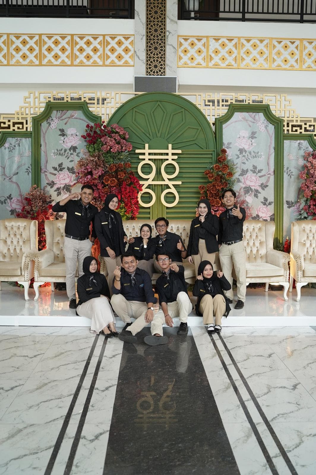 Full ensemble portrait of ByDaisy wedding team in coordinated uniforms