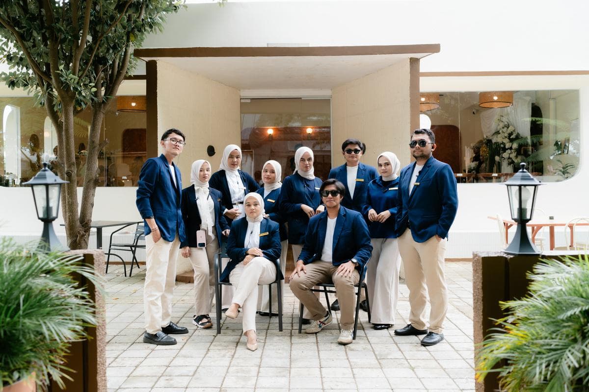 ByDaisy wedding planner crew team posing gracefully in front of an Acehnese dome courtyard